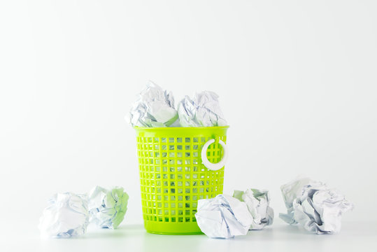 Trash bin and crumpled paper balls