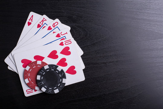 Casino poker chips and playing card with black background