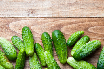 The image of fresh cucumber on a wooden table