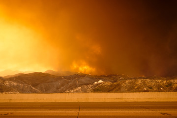 Wildfire in the mountains near freeway