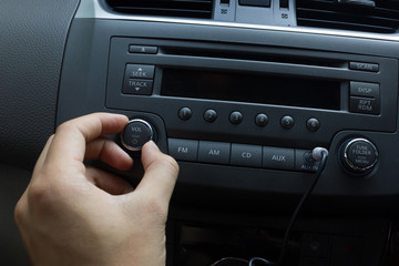 man hand use the radiol switch. Car interior detail