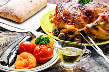 Roasted chicken on wooden plate