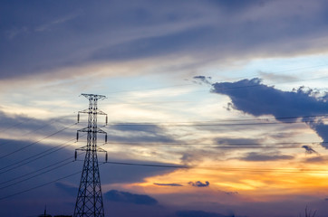 High voltage pole on sunset background