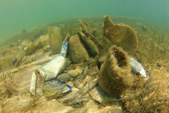 Plastic ocean pollution. Bottles, bags, cans and other rubbish thrown into sea causing environmental problems.