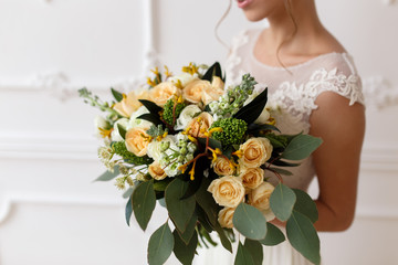 bride holding a bouquet of flowers in a rustic style, wedding bouquet