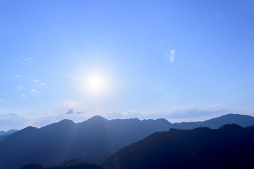 Sun flare with blue sky and mountains