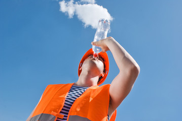 Engineer with safety vest drinking water
