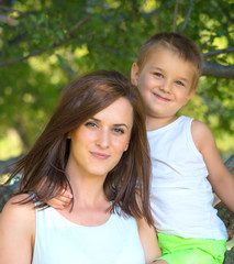 Obraz premium young mother and her son spending time outdoor on a summer day