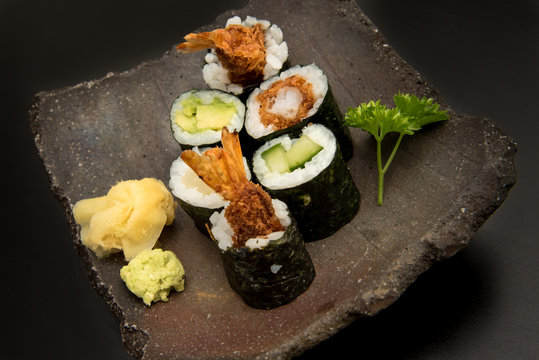 Sushi maki rolls with salmon, avocado and prawns