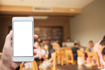 Business conceptual- Focused on left hand holding mobile on cafe blurred background