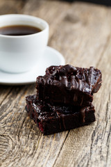 Tasty vegetarian brownie slice on wooden table for celebration.