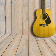 Acoustic guitar on wooden background texture.Copy space
