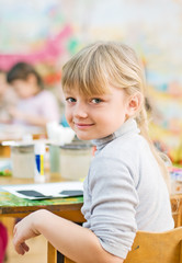 cute little girl sitting and smiling