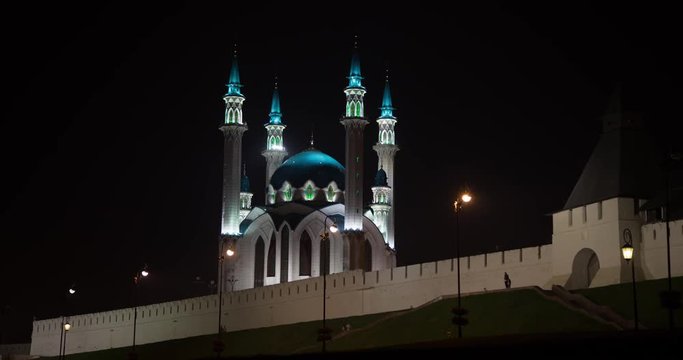 People walk at night near the mosque in the city of Kazan