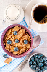 healthy breakfast, coffee cornflakes berries and milk, with text space top view close-up