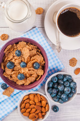 healthy breakfast, coffee cornflakes berries and milk, with text space top view close-up