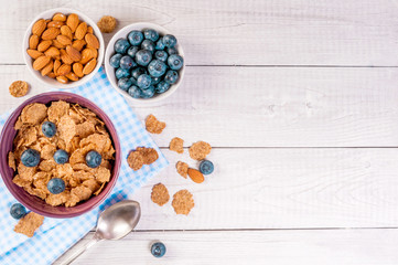 healthy breakfast, cornflakes berries and milk, with text space top view close-up