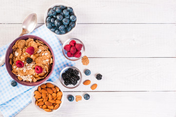 healthy breakfast, coffee cornflakes berries and milk, with text space top view close-up
