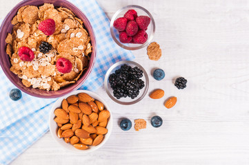 healthy breakfast, coffee cornflakes berries and milk, with text space top view close-up