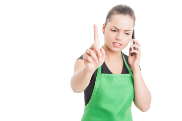Fototapeta premium Serious female employee pointing finger