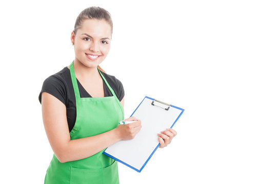 Attractive employee working in supermarket and holding clipboard