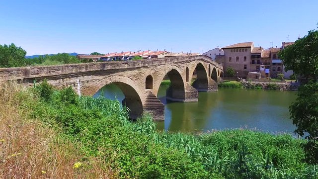 Ancient roman bridge across the Arga river in Puente la Reina, near Pamplona, Navarra, Spain
