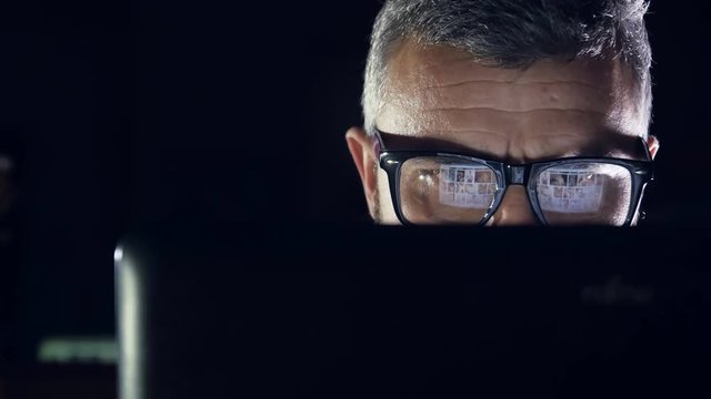 gay man watching nude content on internet reflection on glasses