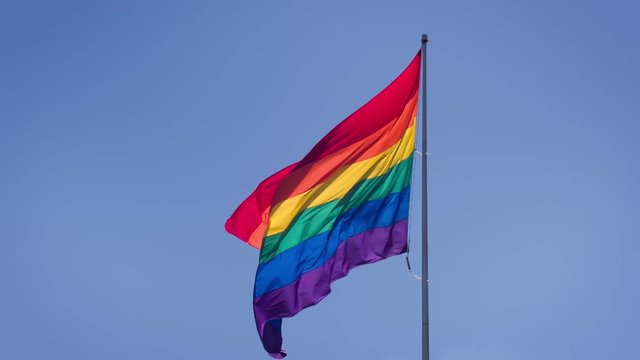 Slow motion gay pride flag blowing in the wind.