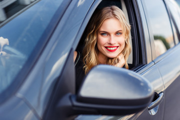 Fototapeta na wymiar Portrait of young beautiful smiling girl in the car