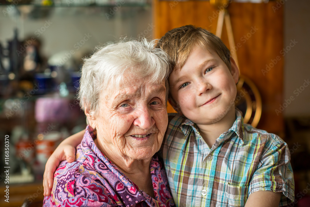 Wall mural portrait of an elderly woman with her little grandson.