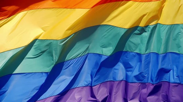 Slow motion gay pride flag blowing in the wind.