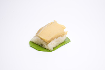 sticky rice with egg custard on green banana leaf. Thai dessert.