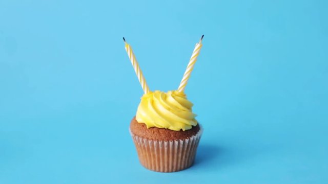 birthday cupcake with two burning candles
