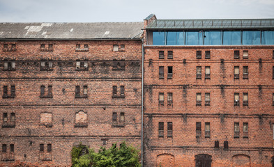 wall of the old factory building of red brick with narrow windows