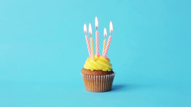 birthday cupcake with five burning candles