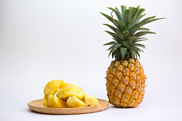 Fototapeta na wymiar Pineapple fruit cut on wooden plate on white background