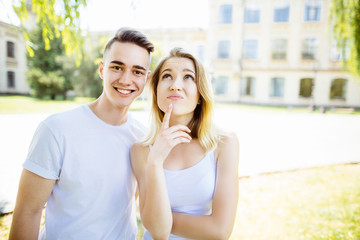 cheerful young couple having fun in the summer park