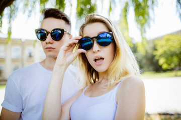 cheerful young couple having fun in the summer park