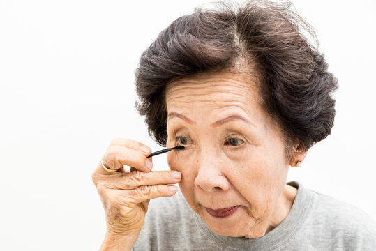 old woman applying make up,asian people, asian women