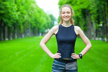 Cheerful young woman before a running session.