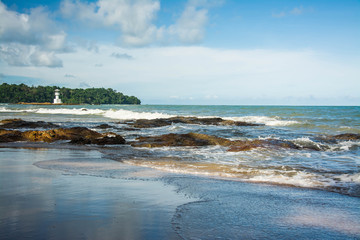 Fototapeta na wymiar Sea waves crashing over rocks on wild stone beach 