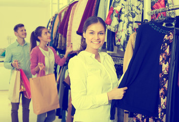 Female assistant serving happy customers