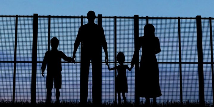 Silhouette of a refugees family with children 
