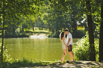 Fototapeta premium Young boy and girl standing on the shore of green lake 6302.