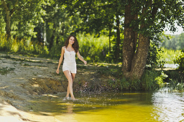 Fototapeta premium Portrait of a girl walking on the water of the lake 6336.