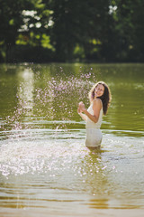 Portrait of a girl standing in the water in the pond 6340.