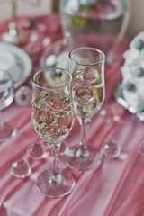 The champagne glasses are on a pink, decorated the table 6447.