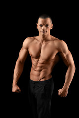 Fototapeta na wymiar Muscular fitness man on black background