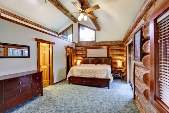Log cabin bedroom with cherrywood furniture set.