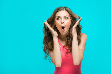 Portrait of young woman with shocked facial expression